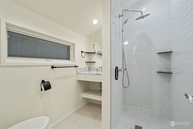 bathroom featuring toilet, a stall shower, vanity, tile patterned flooring, and baseboards