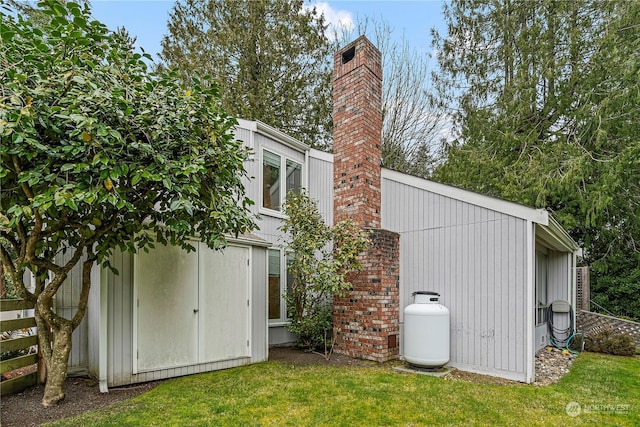 exterior space featuring a yard, a chimney, and fence