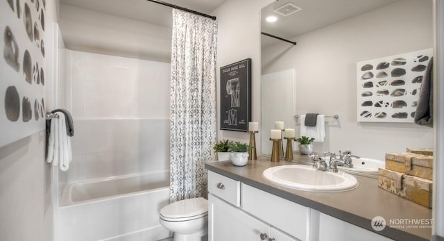 full bathroom featuring vanity, shower / bath combination with curtain, and toilet