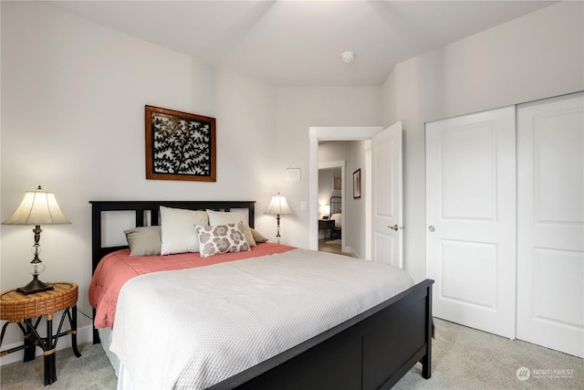 bedroom featuring light carpet and a closet