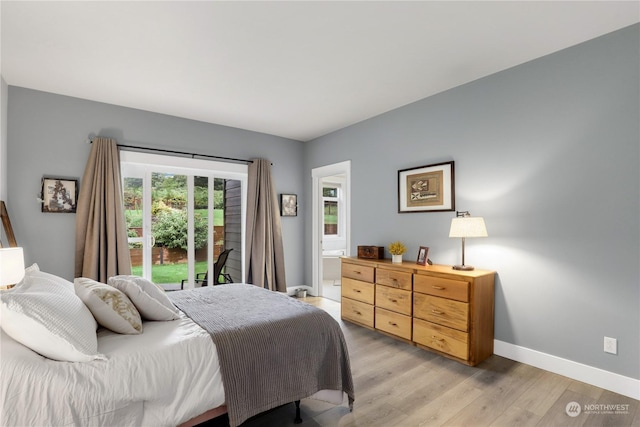 bedroom with connected bathroom and light hardwood / wood-style floors