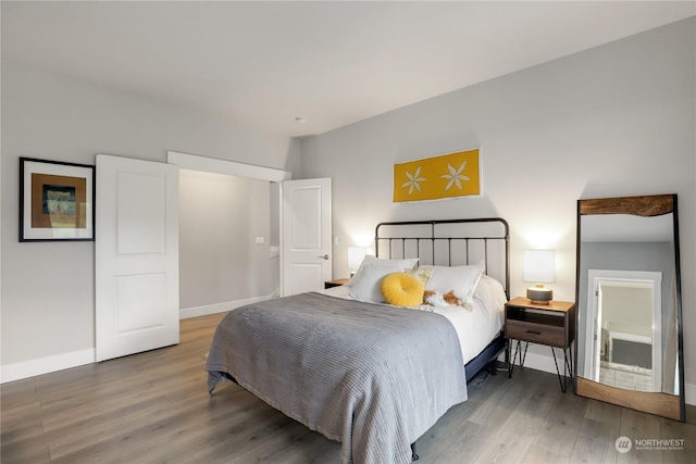 bedroom with dark hardwood / wood-style flooring