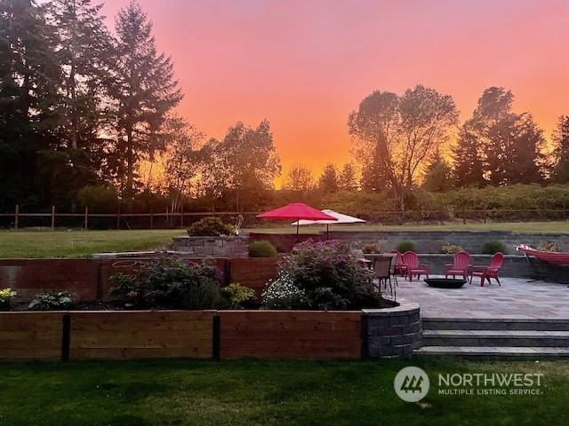 view of property's community with a patio and a yard