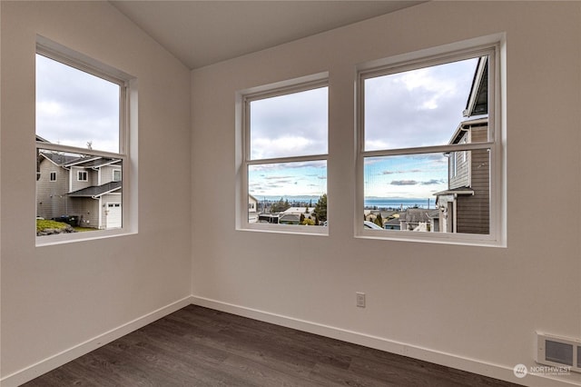 spare room featuring dark wood-type flooring