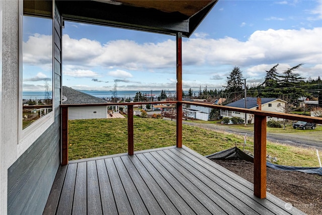 wooden terrace featuring a lawn