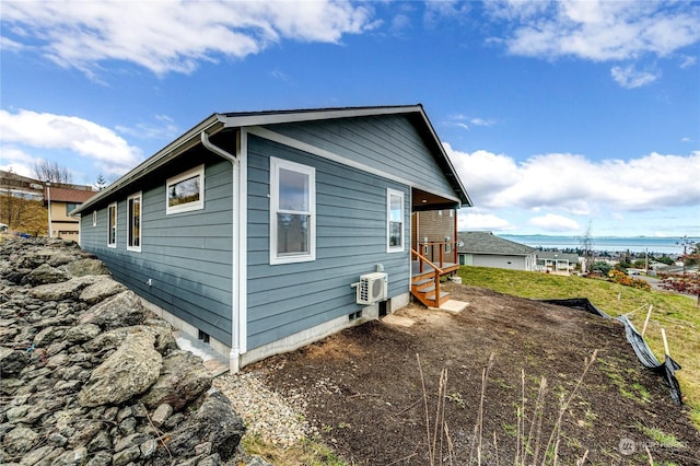 view of property exterior with an AC wall unit