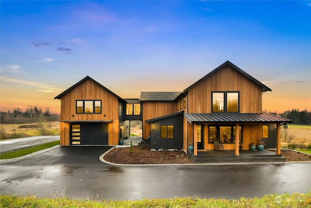 view of front of house featuring a garage and a porch