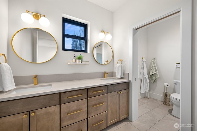 bathroom featuring tile patterned flooring, vanity, and toilet