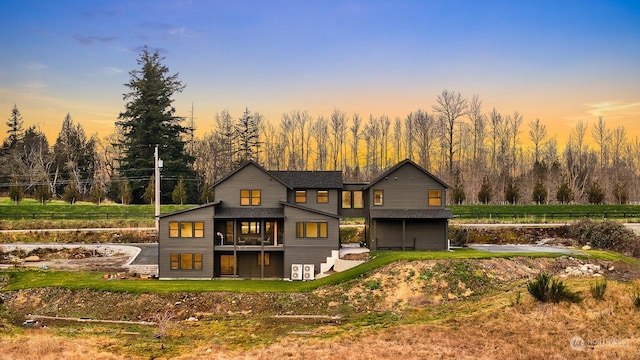 view of back house at dusk