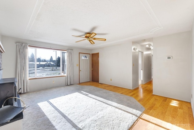 unfurnished living room featuring light wood-type flooring and ceiling fan