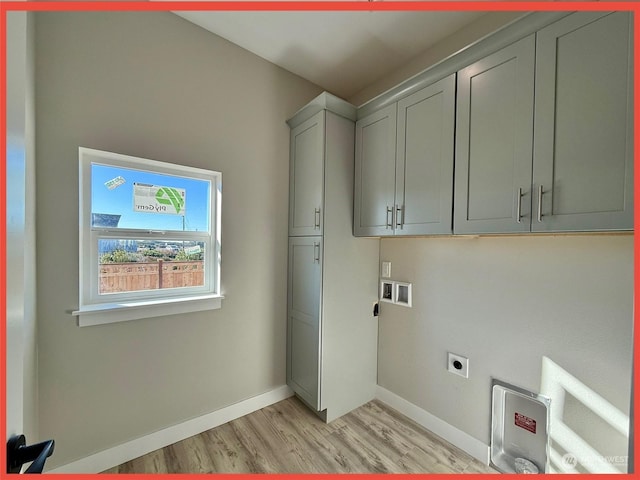 washroom featuring cabinets, light hardwood / wood-style flooring, and hookup for an electric dryer