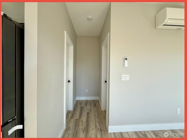 hall featuring light hardwood / wood-style flooring and an AC wall unit