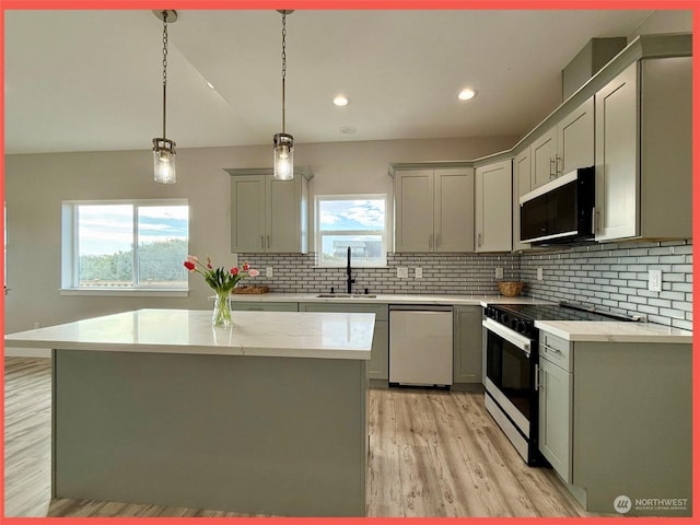 kitchen featuring a center island, sink, dishwasher, and black electric range