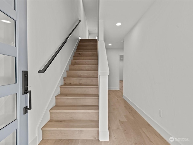 stairs with hardwood / wood-style floors