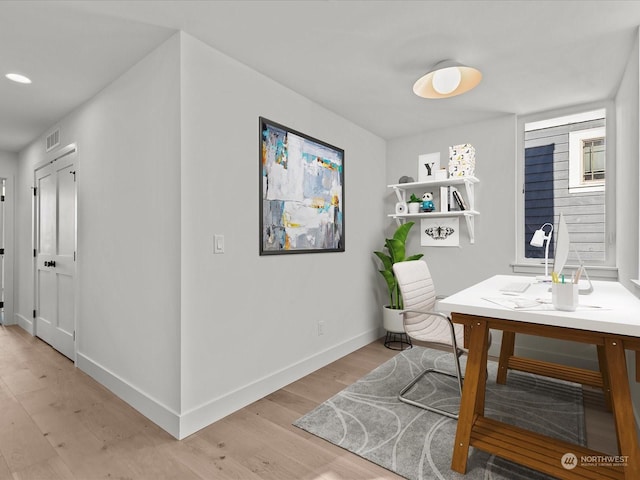 dining area with visible vents, baseboards, and light wood-style floors