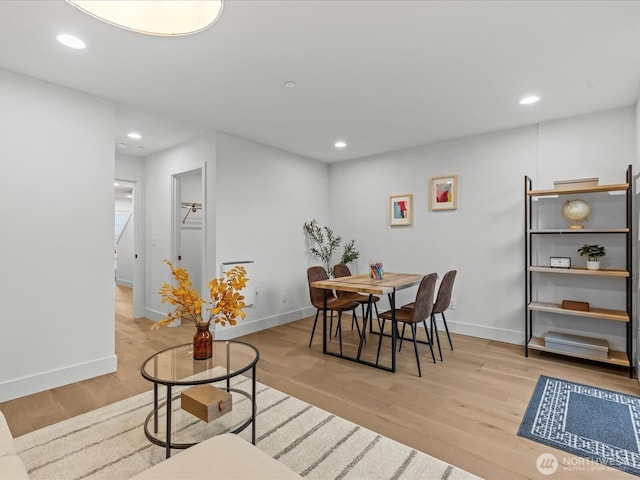 dining space with recessed lighting, baseboards, and light wood finished floors