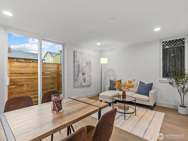 dining room with recessed lighting, baseboards, and wood finished floors