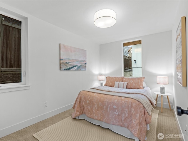 bedroom with baseboards and carpet