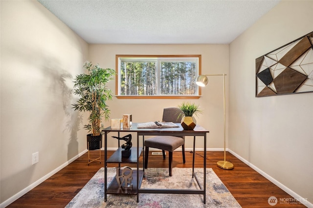 office space with a textured ceiling, baseboards, and wood finished floors