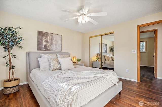 bedroom featuring a ceiling fan, wood finished floors, a closet, and baseboards