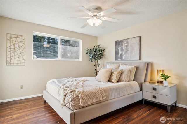 bedroom with baseboards, a textured ceiling, dark wood-style floors, and a ceiling fan