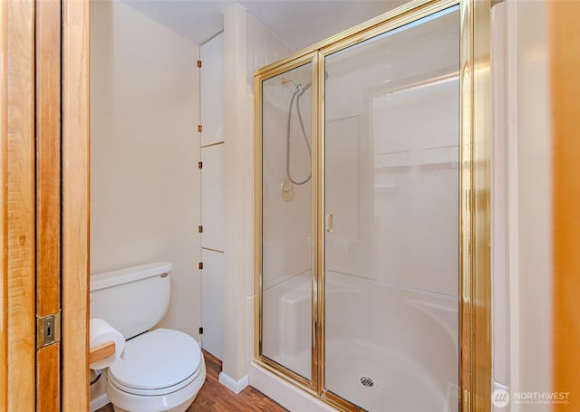 full bathroom featuring toilet and a stall shower