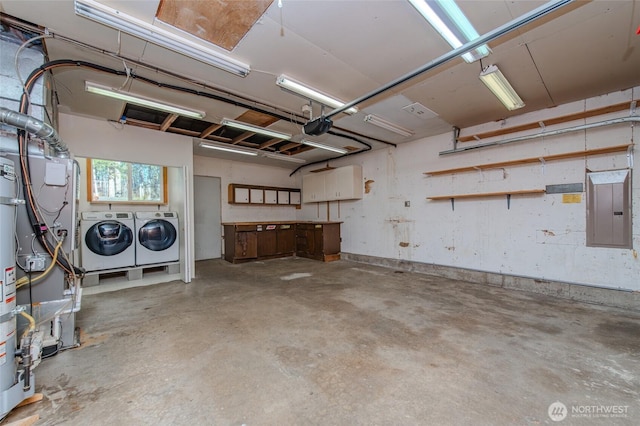 garage with electric panel, a garage door opener, and independent washer and dryer