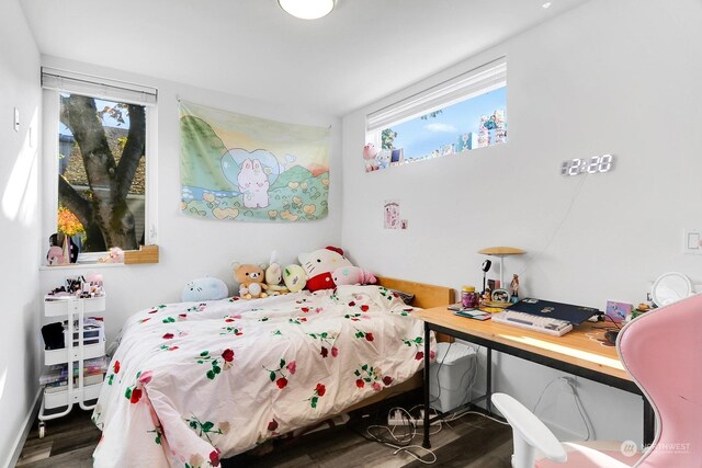 bedroom with dark wood-type flooring