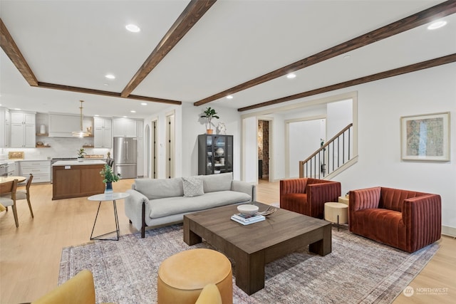 living room with beam ceiling and light hardwood / wood-style flooring