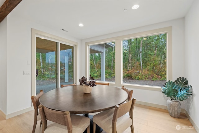 dining space with light hardwood / wood-style floors