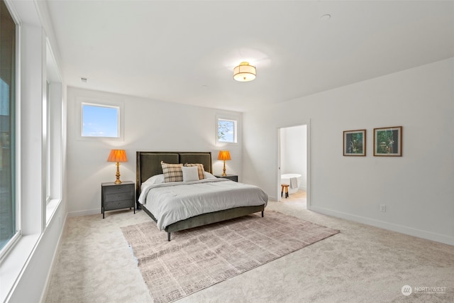 carpeted bedroom featuring ensuite bathroom