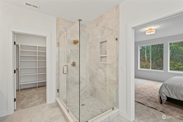 bathroom with a shower with shower door