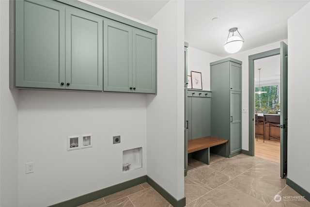 clothes washing area with cabinets, washer hookup, and hookup for an electric dryer