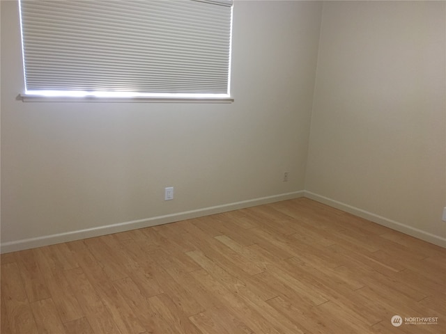 spare room with light hardwood / wood-style flooring