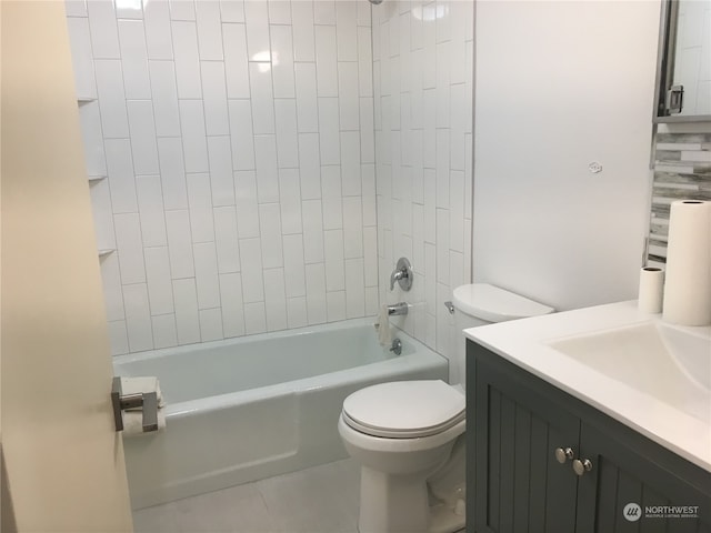 full bathroom featuring vanity, tiled shower / bath combo, tile patterned floors, and toilet