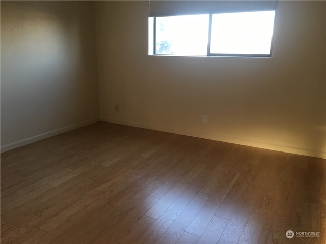 spare room featuring hardwood / wood-style flooring