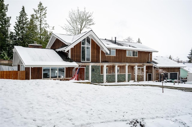 view of snow covered back of property