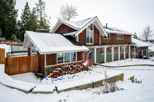 view of snow covered back of property