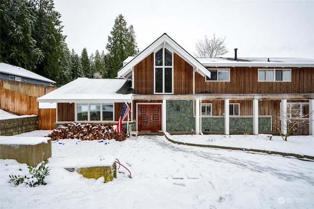 view of snow covered rear of property