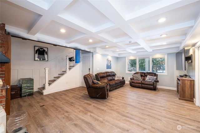 living room with beamed ceiling, coffered ceiling, and light hardwood / wood-style flooring