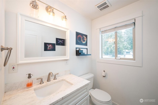 bathroom with vanity and toilet