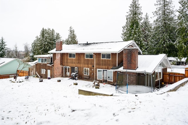 view of snow covered rear of property