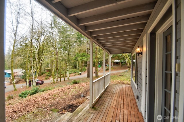 wooden terrace featuring covered porch