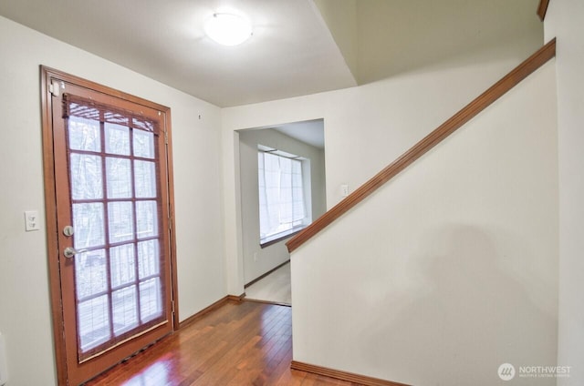 doorway to outside featuring a wealth of natural light, stairway, and hardwood / wood-style flooring