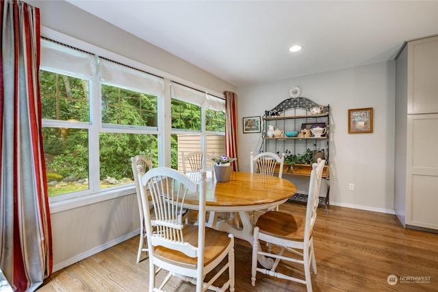 dining space featuring light wood-type flooring