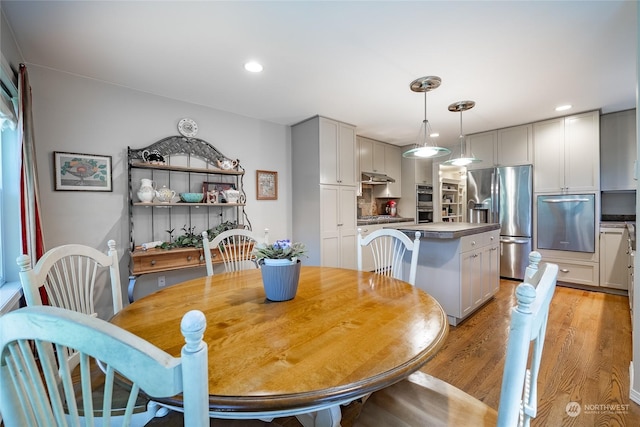 dining space with light hardwood / wood-style flooring