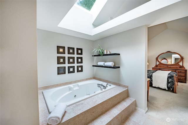 bathroom with tiled tub and lofted ceiling with skylight