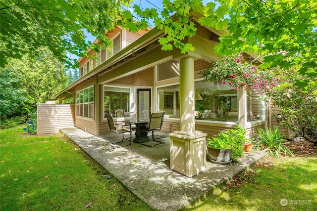 exterior space with a patio area and a lawn