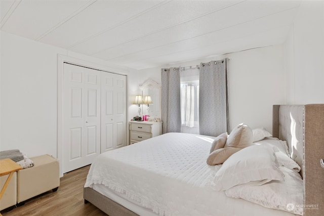 bedroom with hardwood / wood-style flooring and a closet