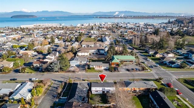 birds eye view of property featuring a water and mountain view